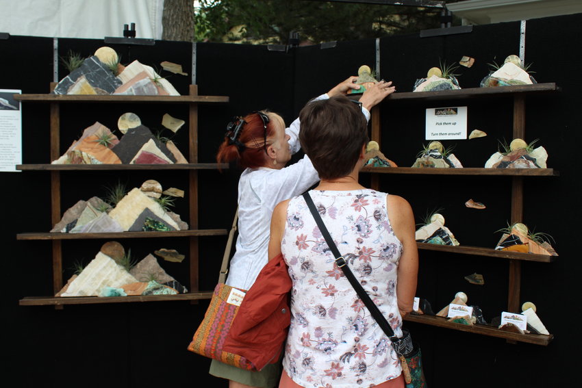 Attendees look over works by Mountain Sculpture Studios at the Golden Fine Arts Festival Aug. 20 in downtown Golden.
